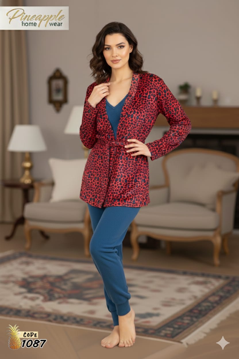 Woman wearing a red patterned cape and blue pants in a living room setting.