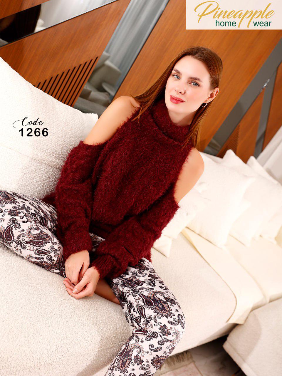 Woman wearing a maroon sweater and patterned pants sitting on a couch with 'Pineapple Home Wear' branding.