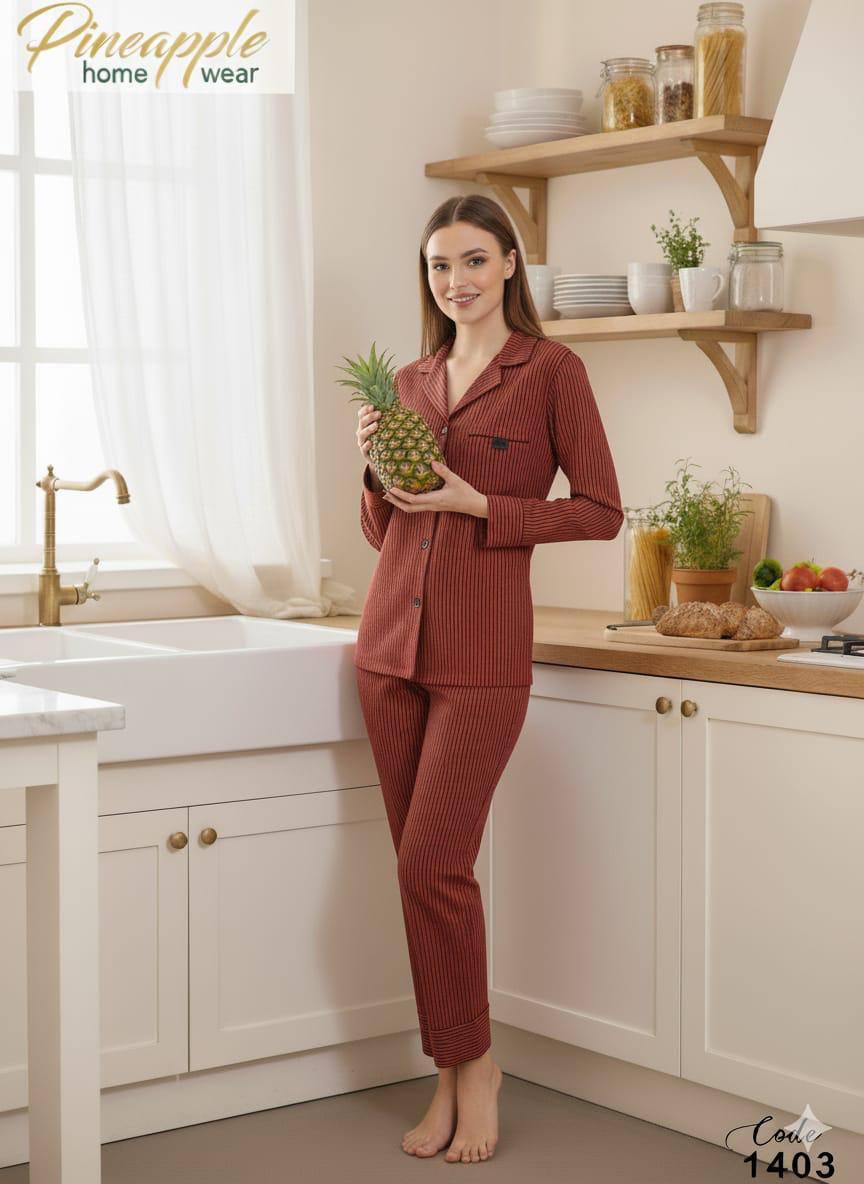 Woman in red pajama set holding a pineapple in a kitchen, with 'Pineapple Home Wear' branding.