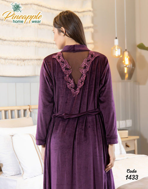 Woman wearing a purple robe with lace details in a bedroom setting, branded 'Pineapple Home Wear'.