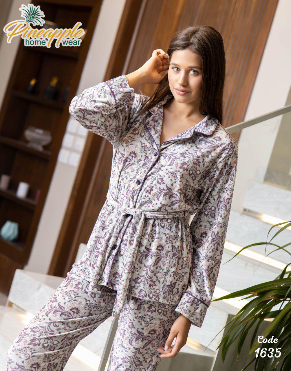 Woman wearing a floral pajama set with 'Pineapple Home Wear' branding.