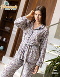 Woman wearing a floral pajama set with 'Pineapple Home Wear' branding.