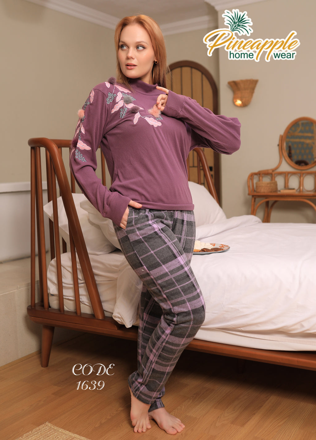 Woman wearing a purple top and plaid pants in a bedroom setting, with 'Pineapple Home Wear' branding.