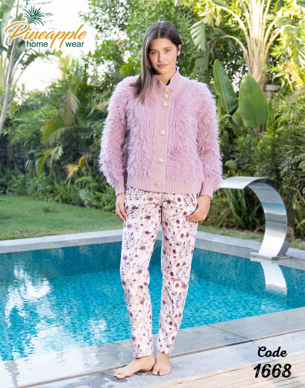 Woman in pink fuzzy cardigan and patterned pants standing by a pool with 'Pineapple Home Wear' branding.