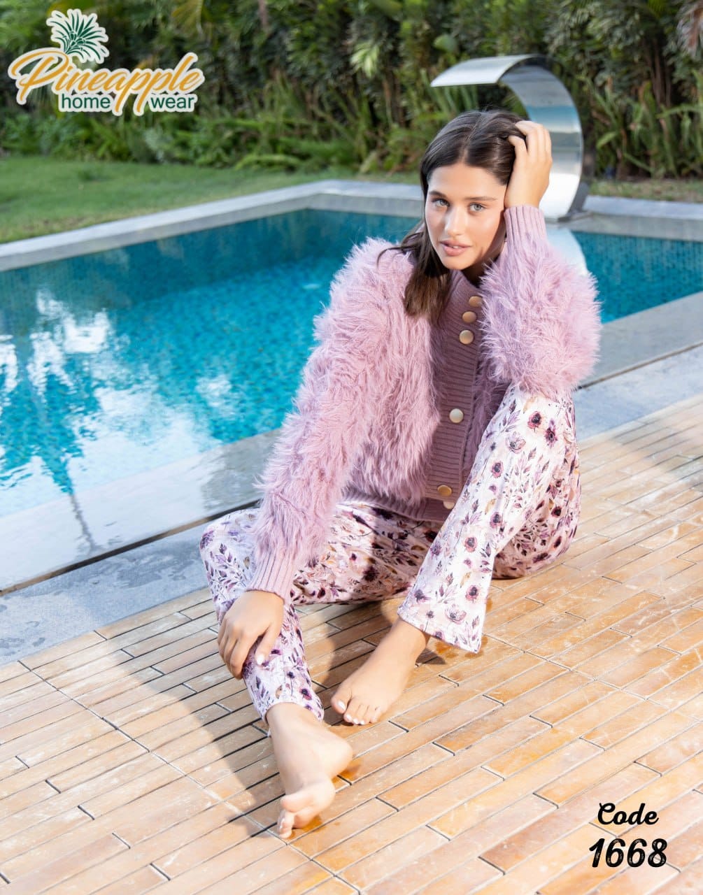 Woman in pink fuzzy robe and patterned pants sitting by a pool, with 'Pineapple Home Wear' branding.