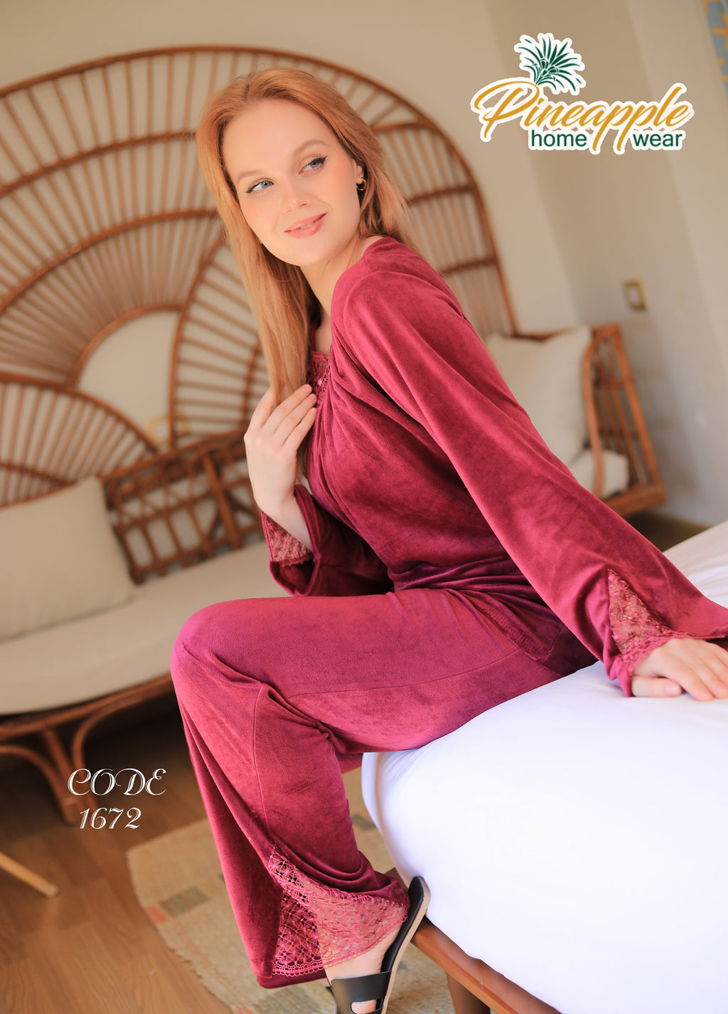 Woman in burgundy pajama set sitting on a bed with 'Pineapple Home Wear' branding.
