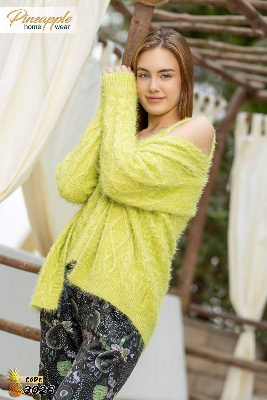 Woman wearing a bright yellow sweater with a blurred outdoor background