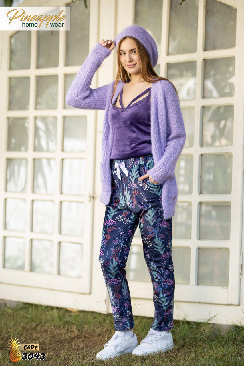 young woman modeling a purple loungewear set from the brand "Pineapple home wear"