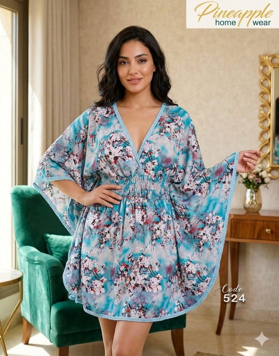 Woman wearing a floral kimono-style dress in a home setting with 'Pineapple Home Wear' branding.