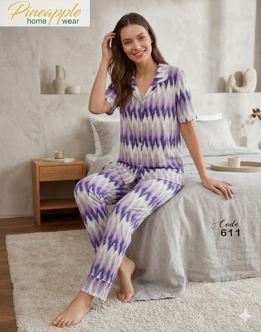 Woman wearing a purple and white tie-dye pajama set in a home setting with 'Pineapple Home Wear' branding.