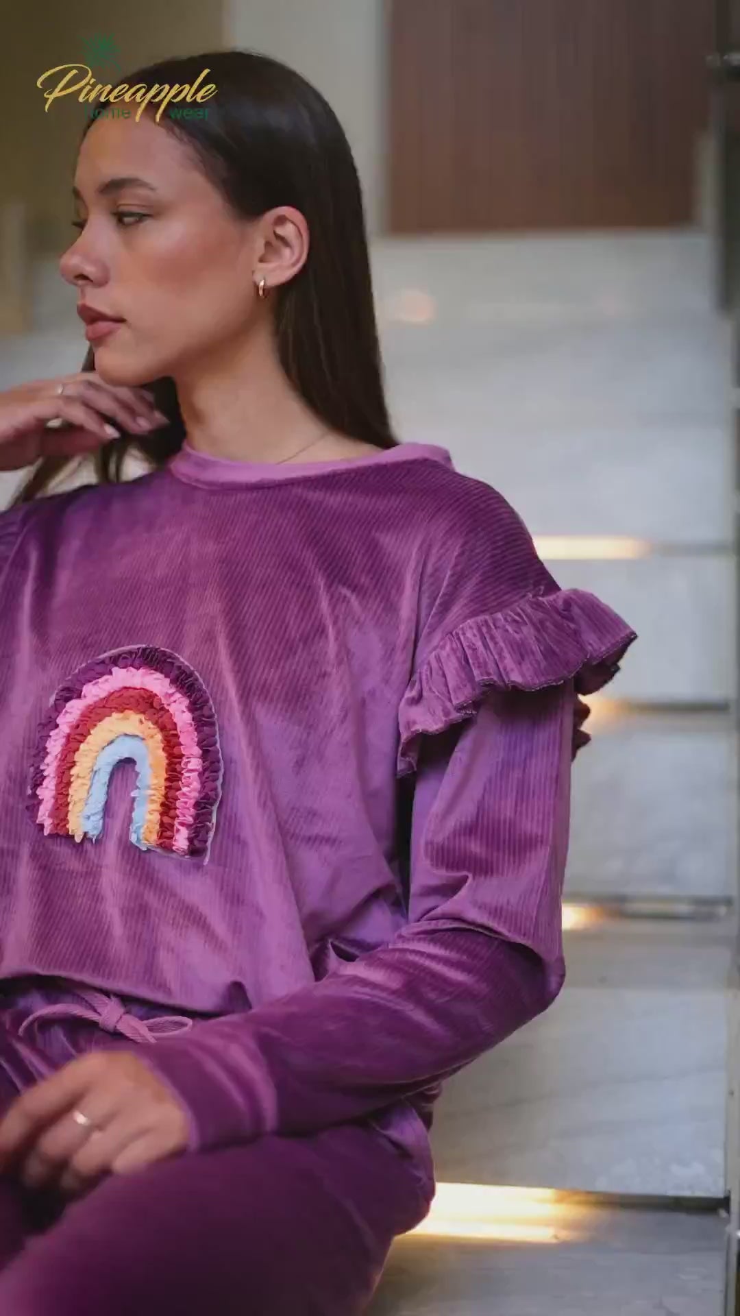 Woman in purple outfit with rainbow design 